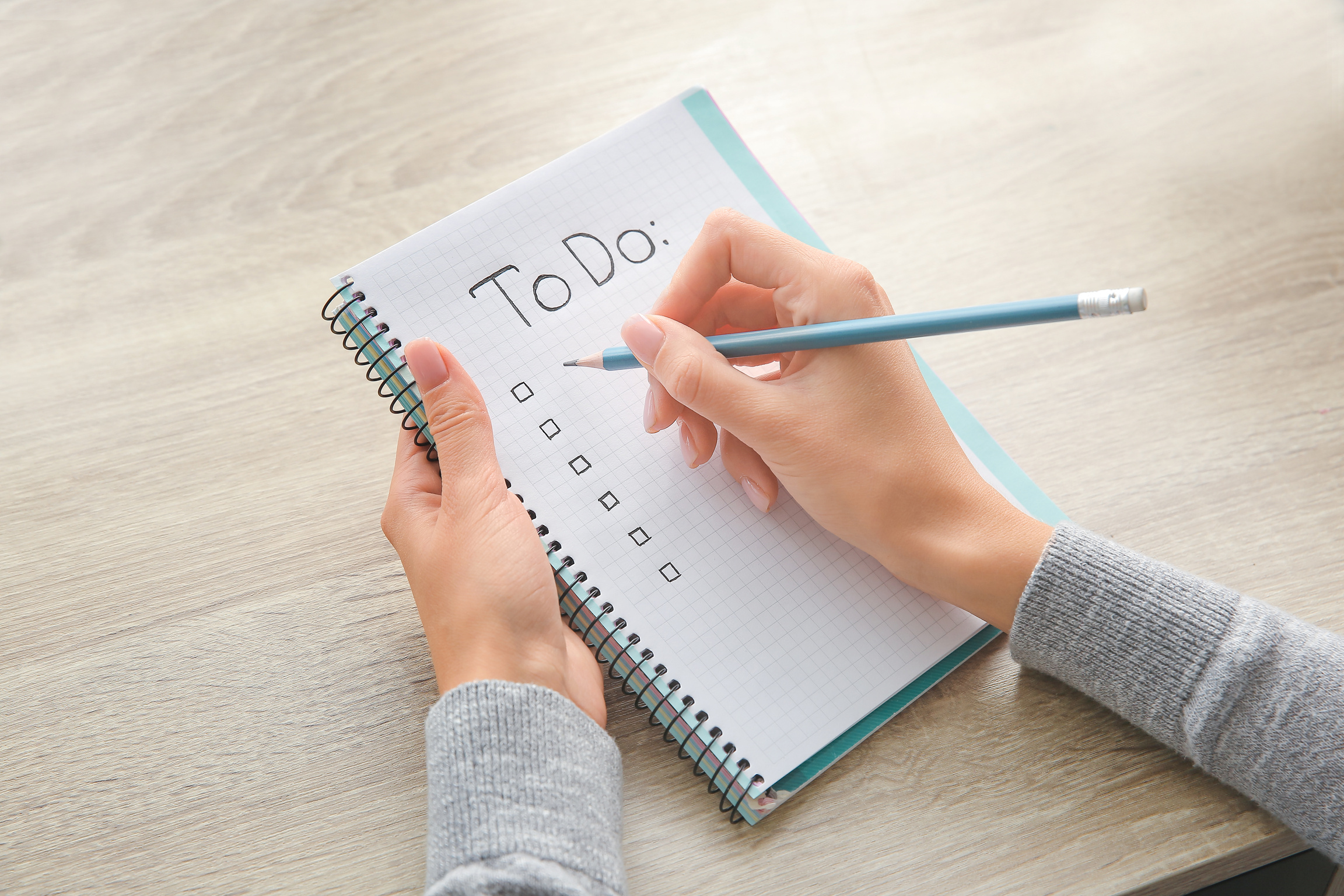 Woman Making to-Do List at Table